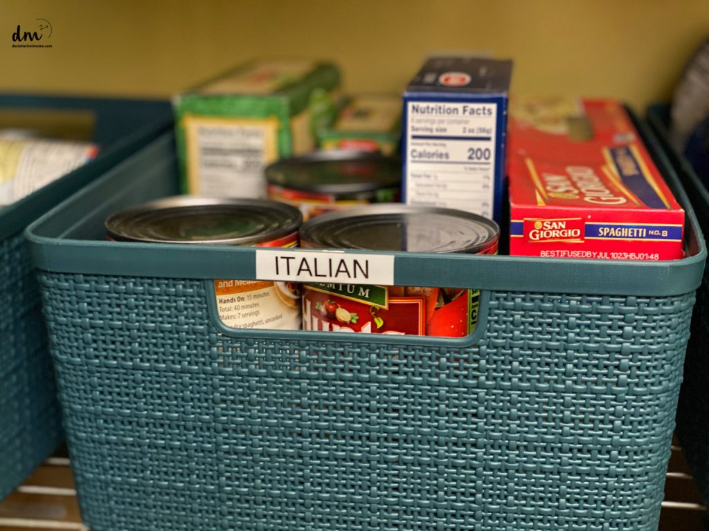 a blue basket labeled Italian filled with italian food