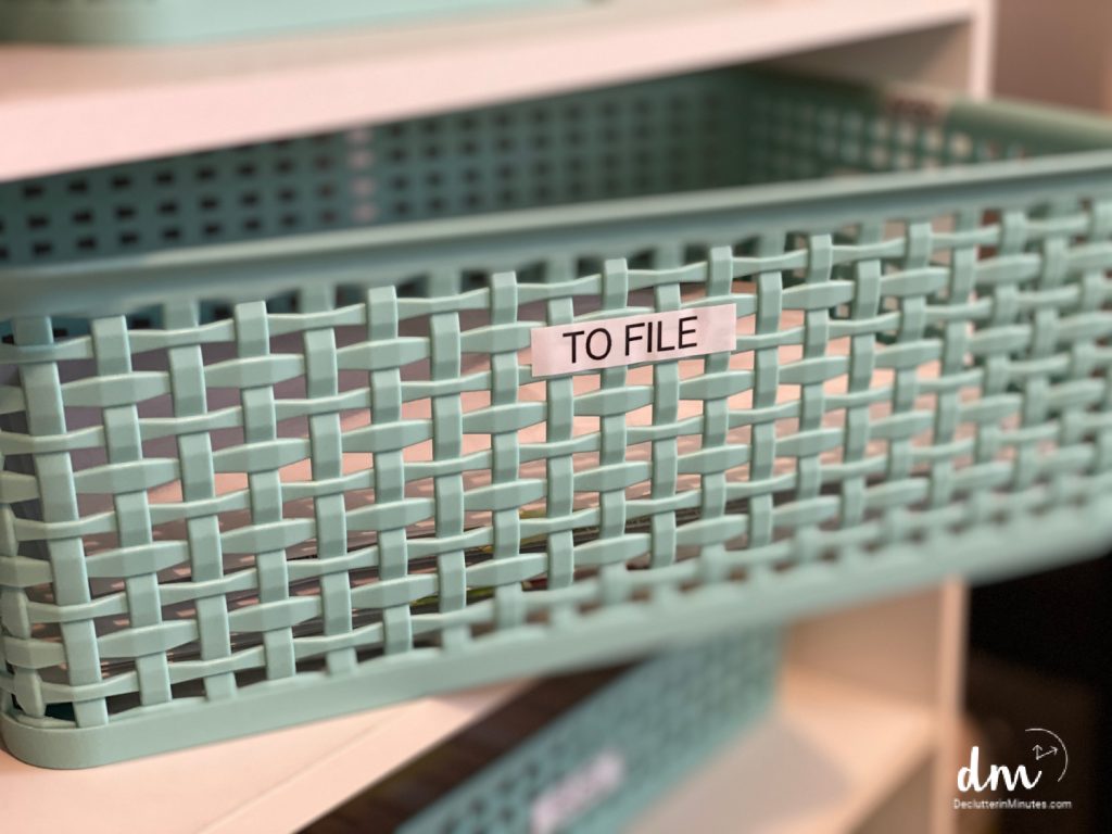 a teal basket labeled _to file_ on the front