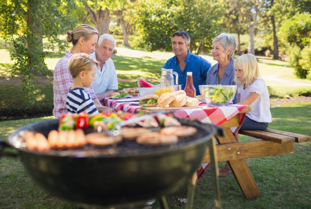 Happy family having picnic in the park on a sunny day