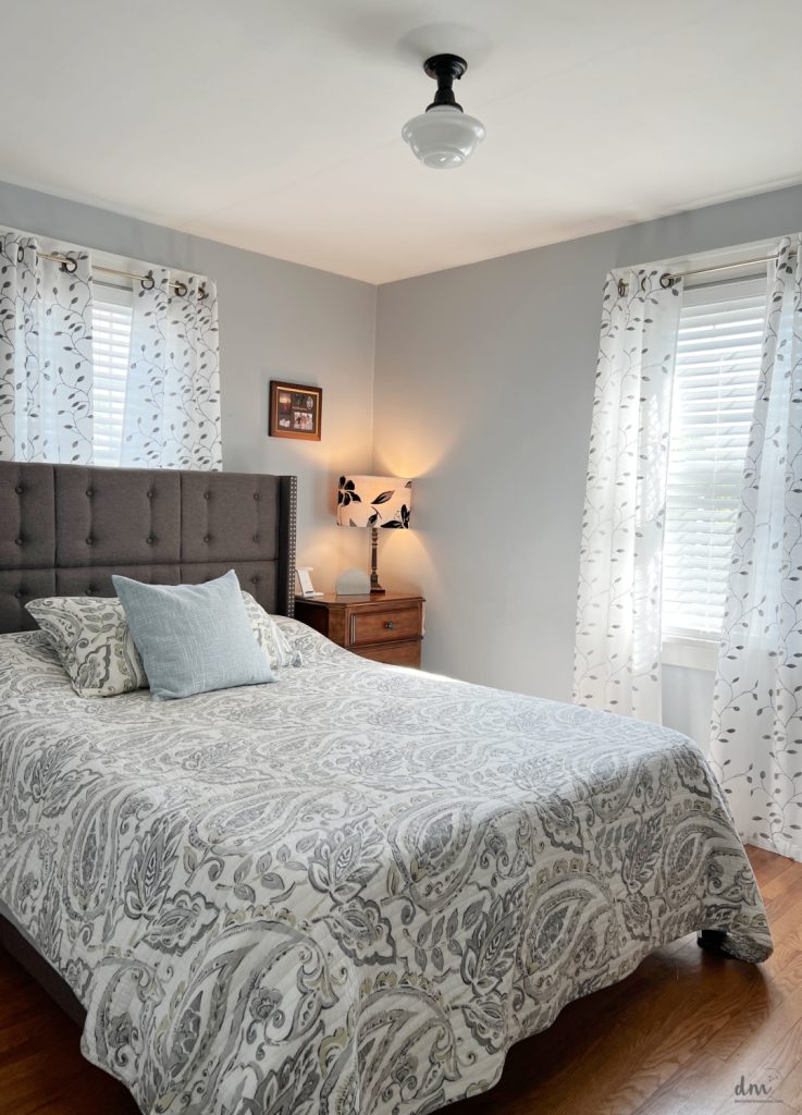 a bed and nightstand in a small bedroom