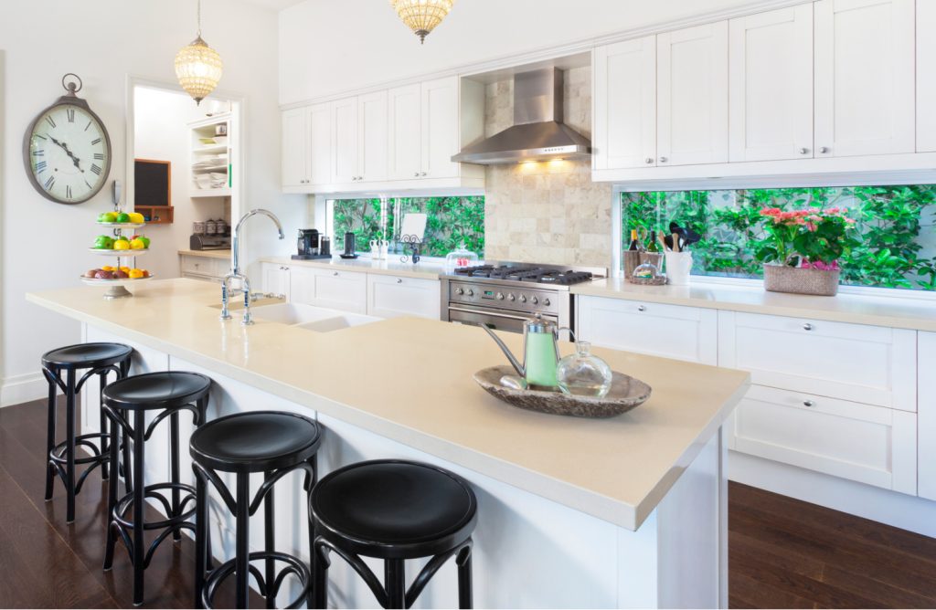 a neat and tidy kitchen with white cabinets