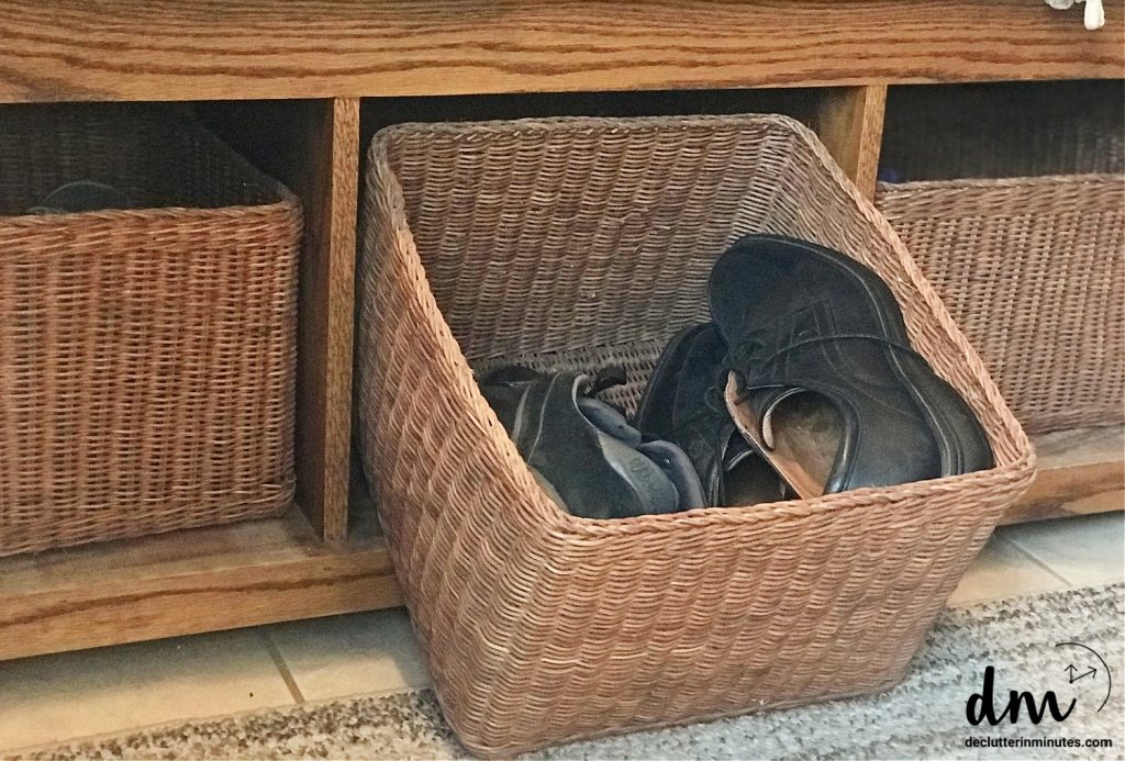 a basket of shoes in a bench of a mudroom 