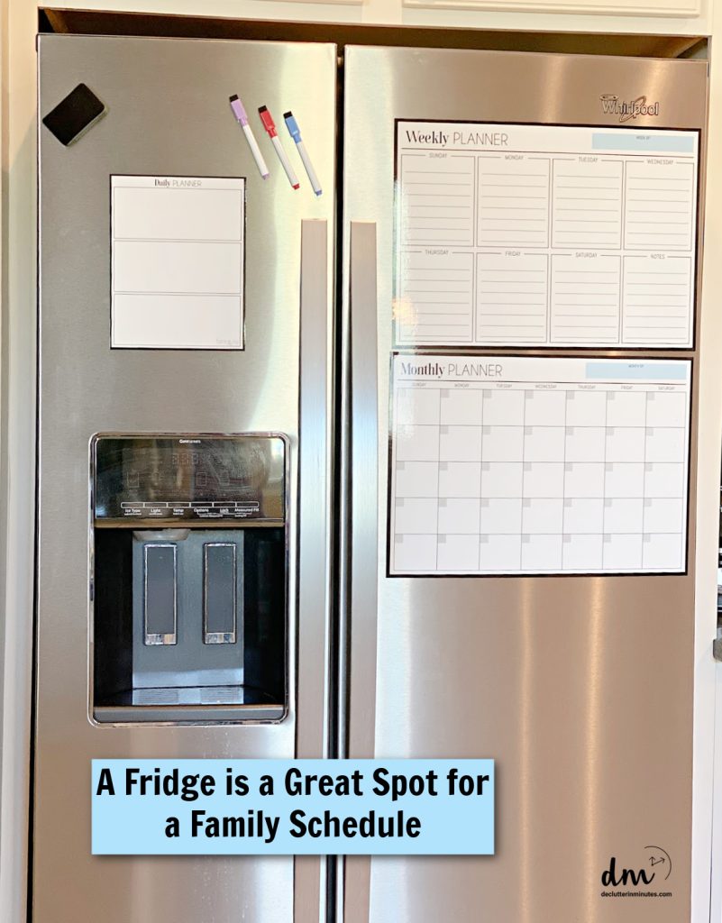 a steel fridge with calendars and planners on the front