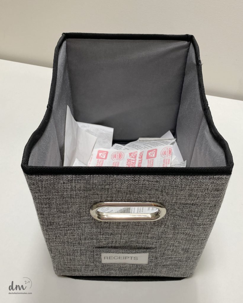 a gray basket full of receipts