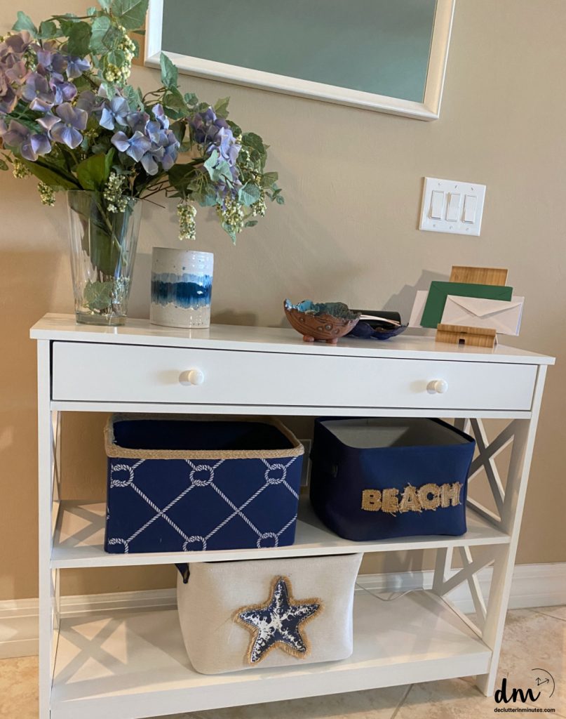 a counter in a home with containers on it to hold mail and car keys
