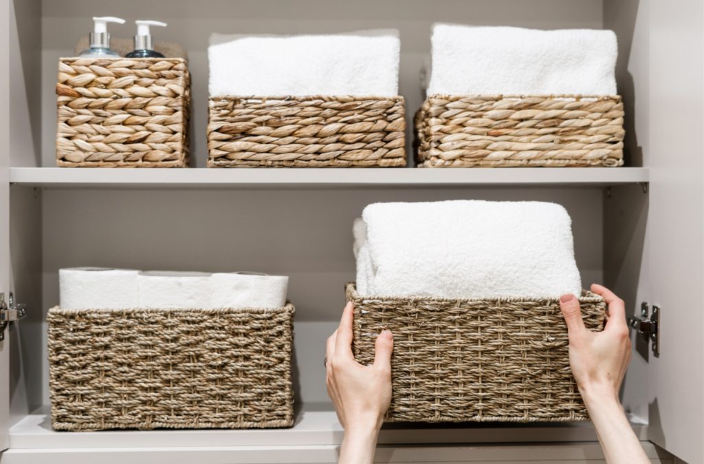 baskets of towels and soaps in a linen closet