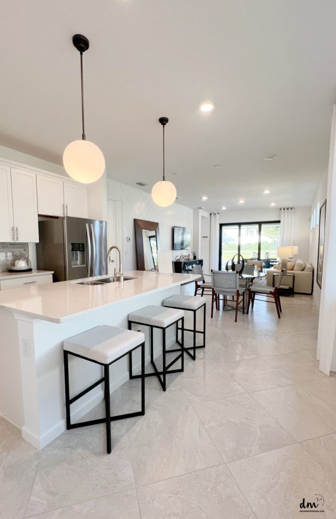 a neat and organized home with a bar and stools lined up