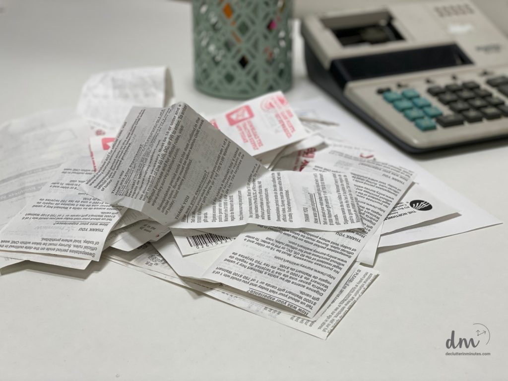 a pile of receipts near to a calculator