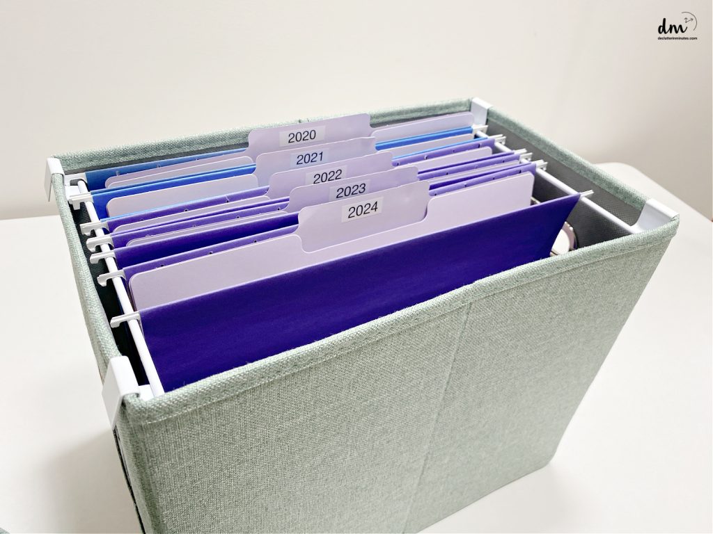 colored files in a green bin organizer