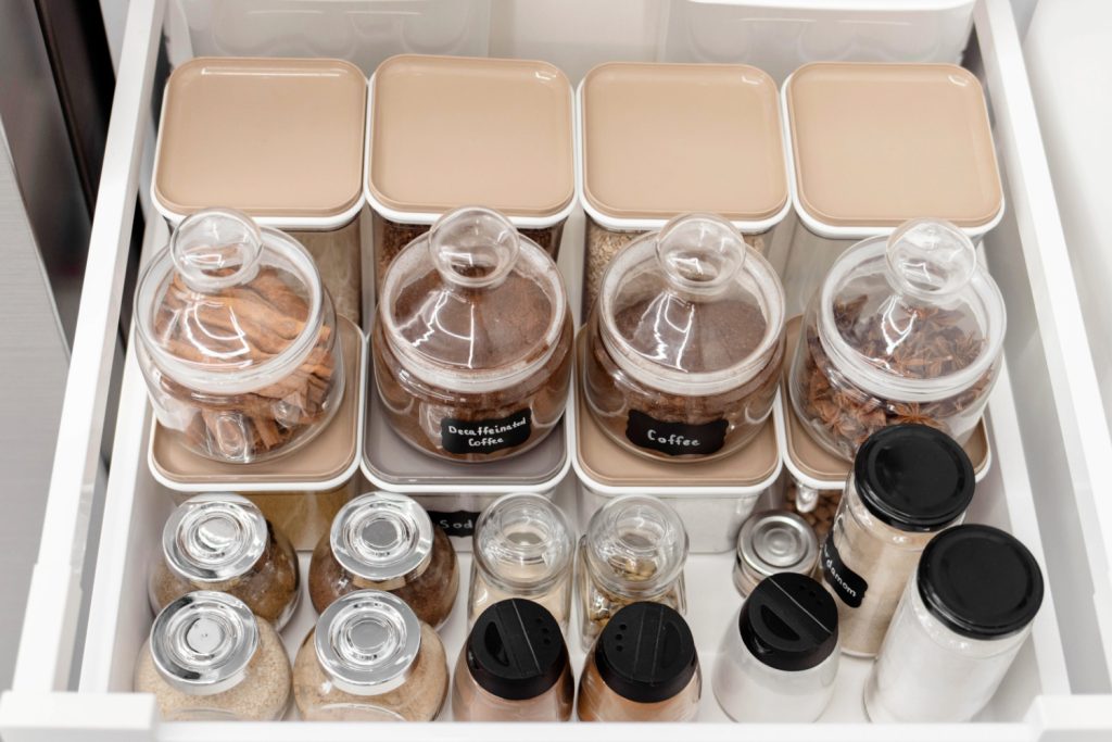 spice jars and seasoning containers in a drawer