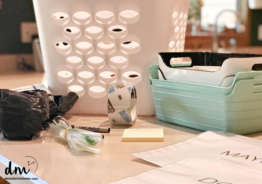 a collection of markers, bags, baskets and sorting labels on a counter