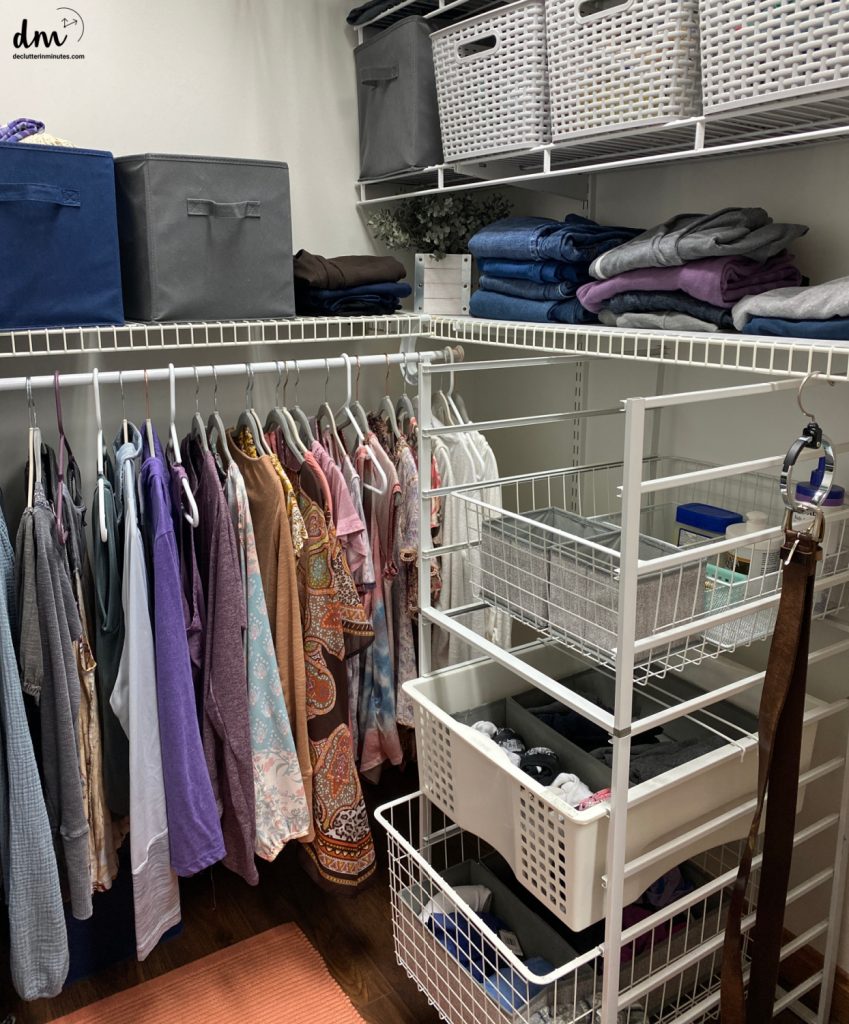 an organized closet with baskets, drawers, and hanging items