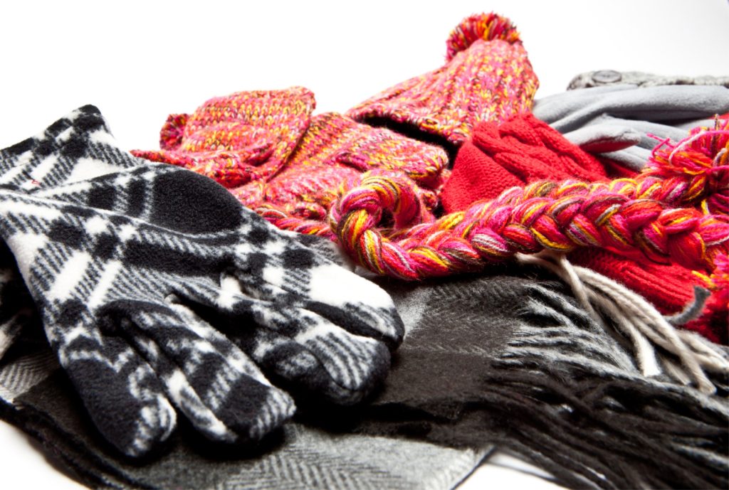 things to declutter in december - a pile of hats gloves and scarves