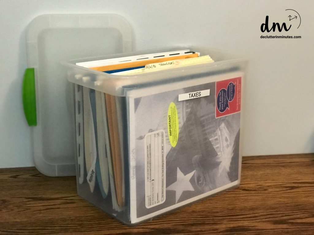 a plastic file tote labeled taxes on the front
