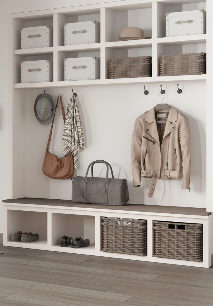a storage bench with hooks and wall cubbies in a mudroom of a home