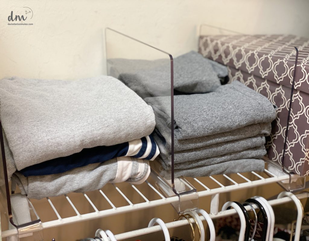 sweats and tank tops folded and on a shelf in a closet