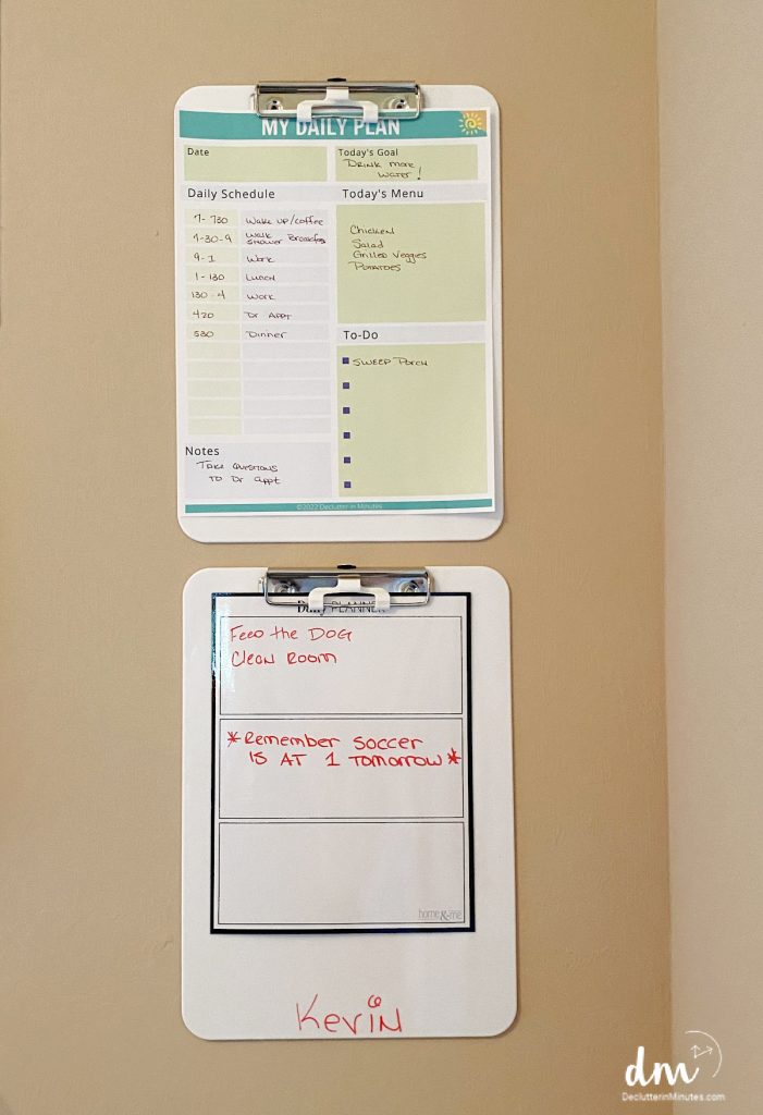 2 clipboards on a wall with lists on each one