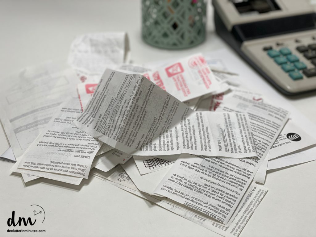 A pile of receipts next to a calculator