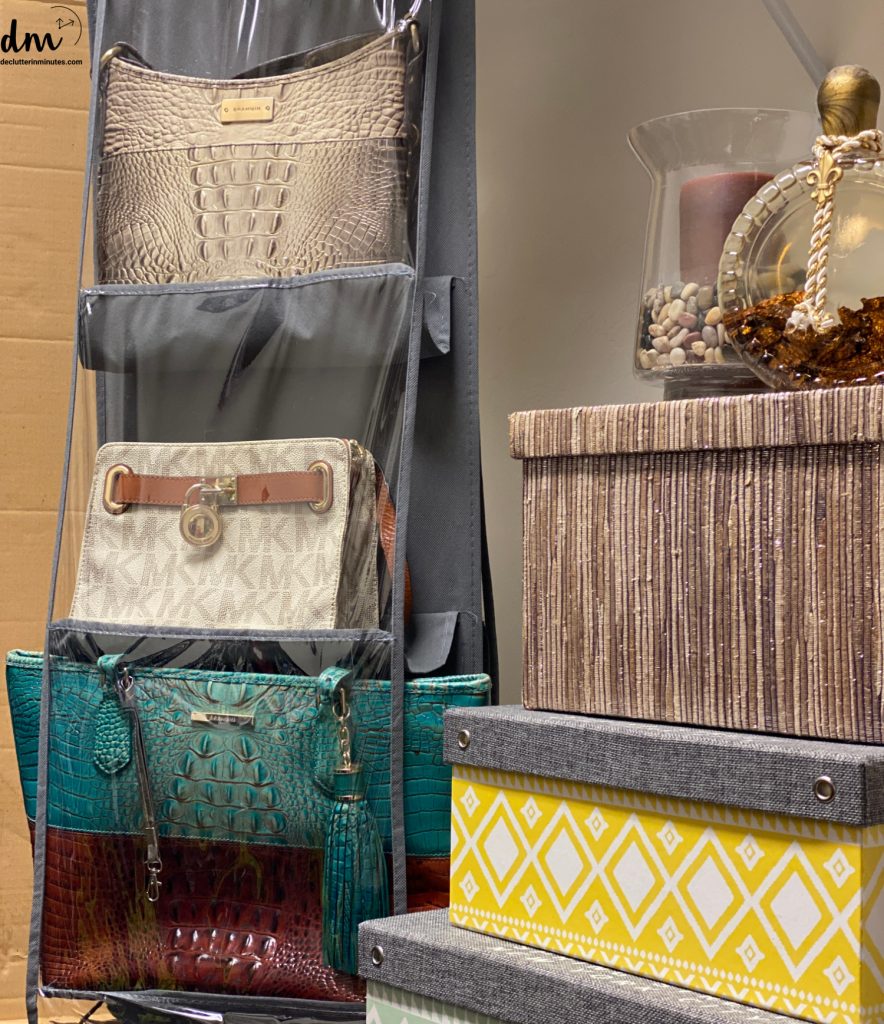 a purse organizer in a closet next to colorful boxes