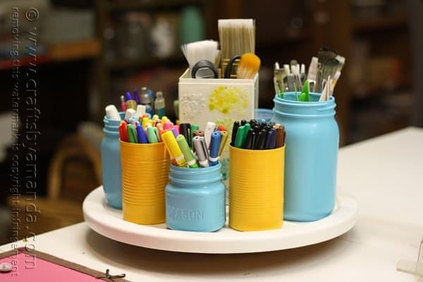 Lazy susan with pens, paintbrushes, scissors and other craft supplies