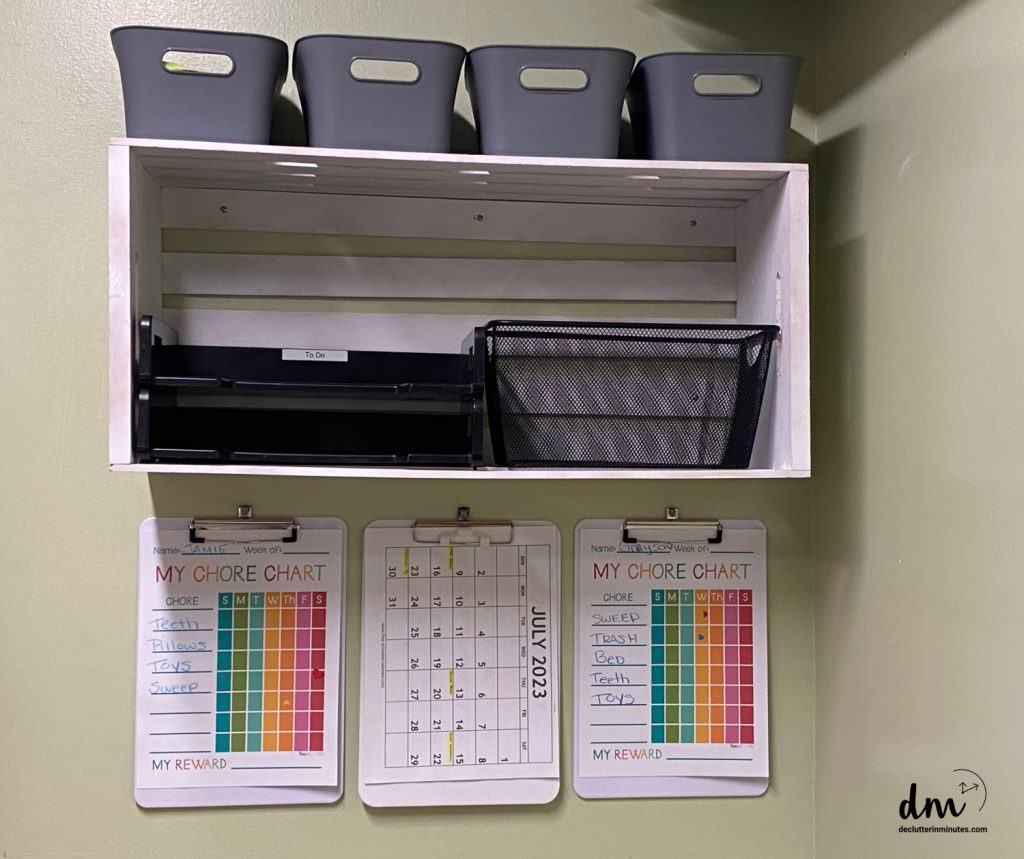 a white shelf home hub with gray bins and 3 clipboards