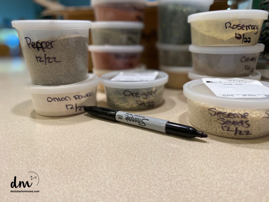 spices in small plastic containers with labels