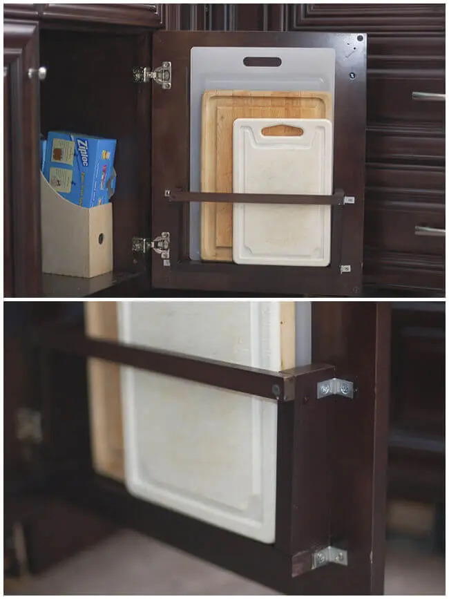 Two images showing a behind-the-door cutting board holder in a kitchen cabinet - the top image displays a small compartment with storage items, and the bottom image highlights cutting boards secured by a bar on the cabinet door