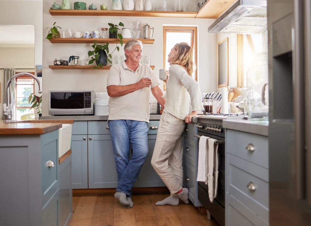 a couple talking in a kitchen