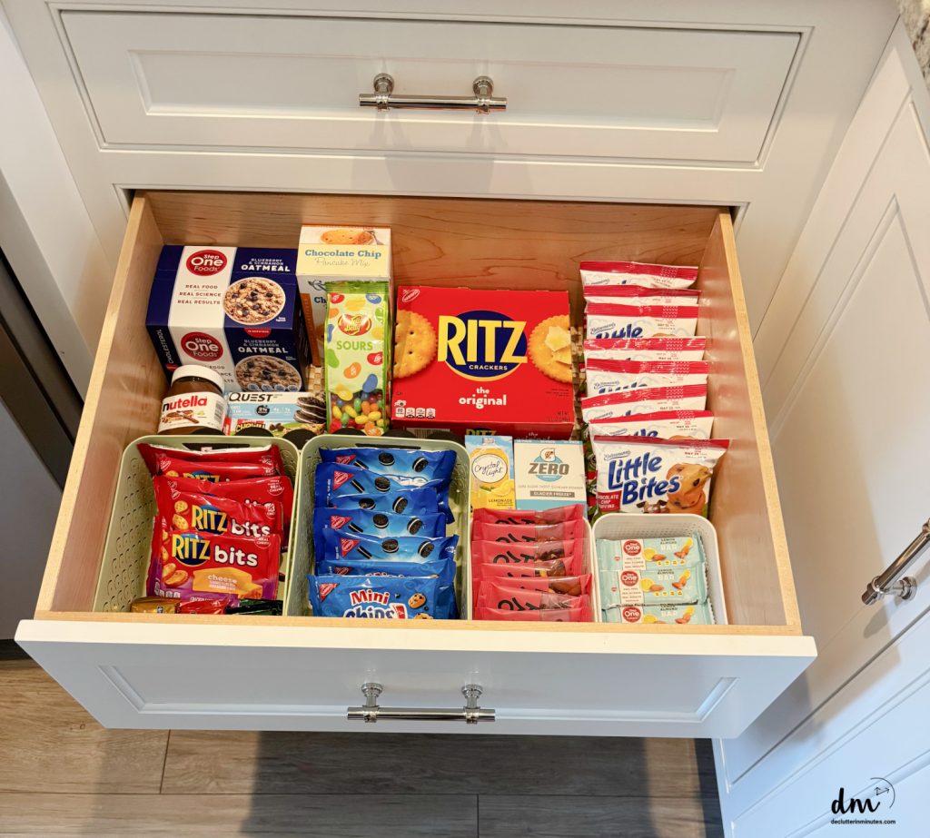 a drawer in a pantry filled with snacks