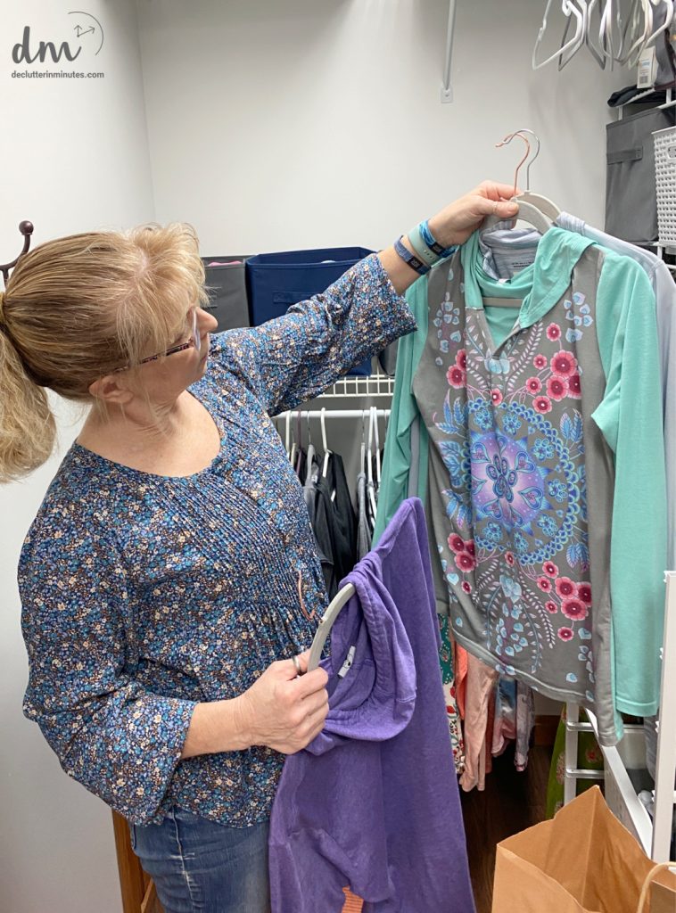 woman sorting clothes in a closet