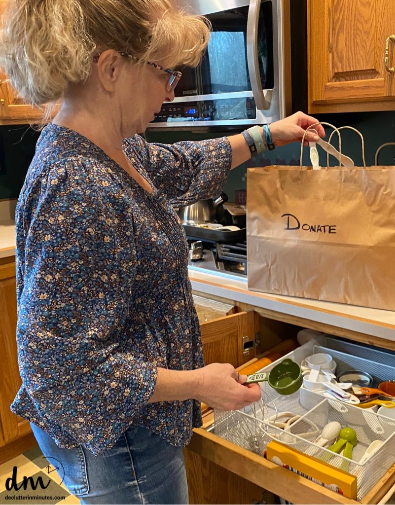a woman putting a measuring spoon into a bag labeled donation on the front