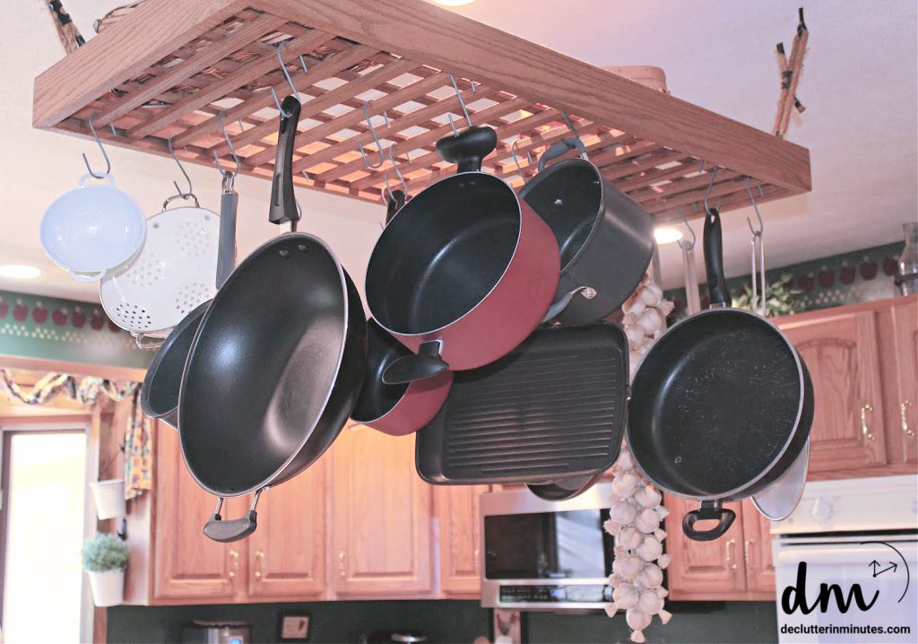 a-rack-hanging-from-a-kitchen-ceiling-holding-pots