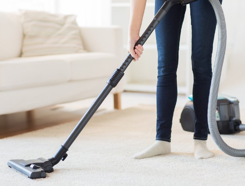 woman-vacuuming-a-carpet-in-a-family-room-