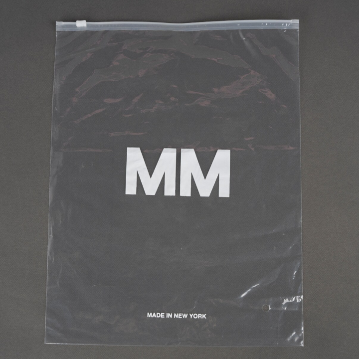 A clear plastic zipper bag with the letters "MM" printed in white and "Made in New York" written at the bottom