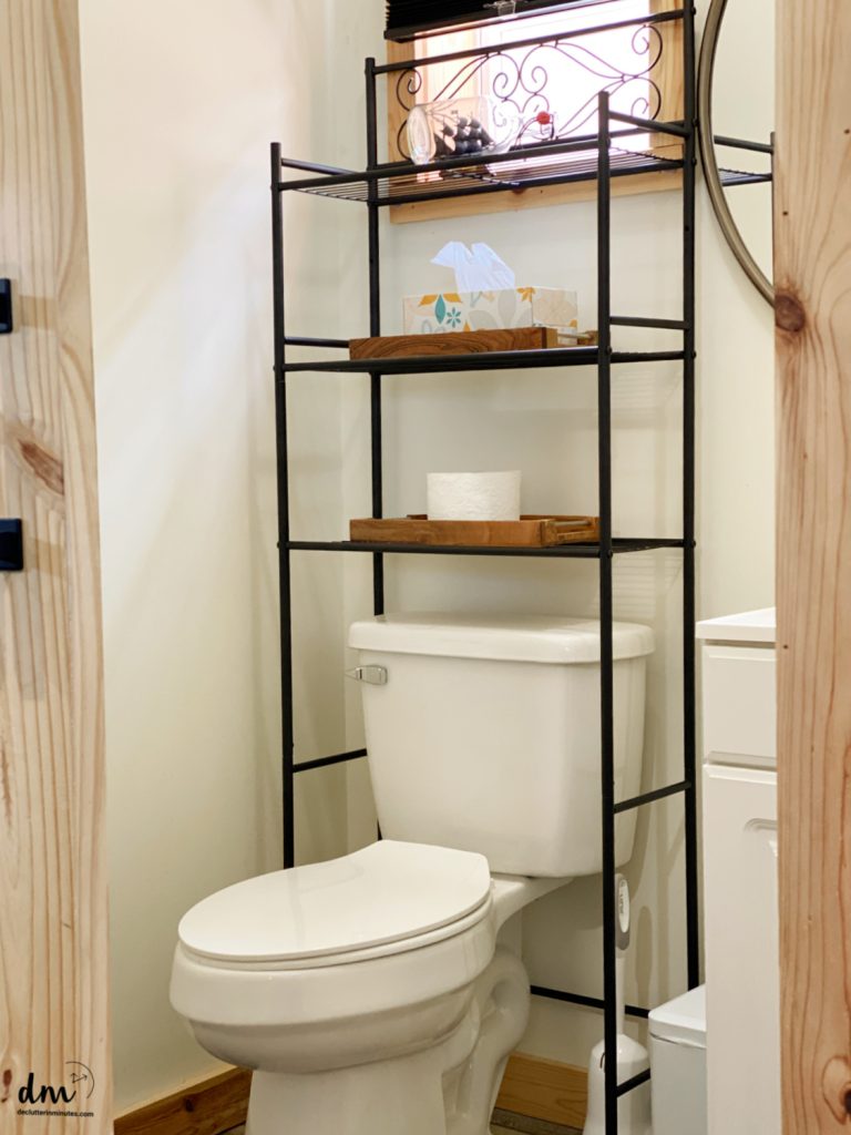 a vertical storage shelf over a toilet in a bathroom
