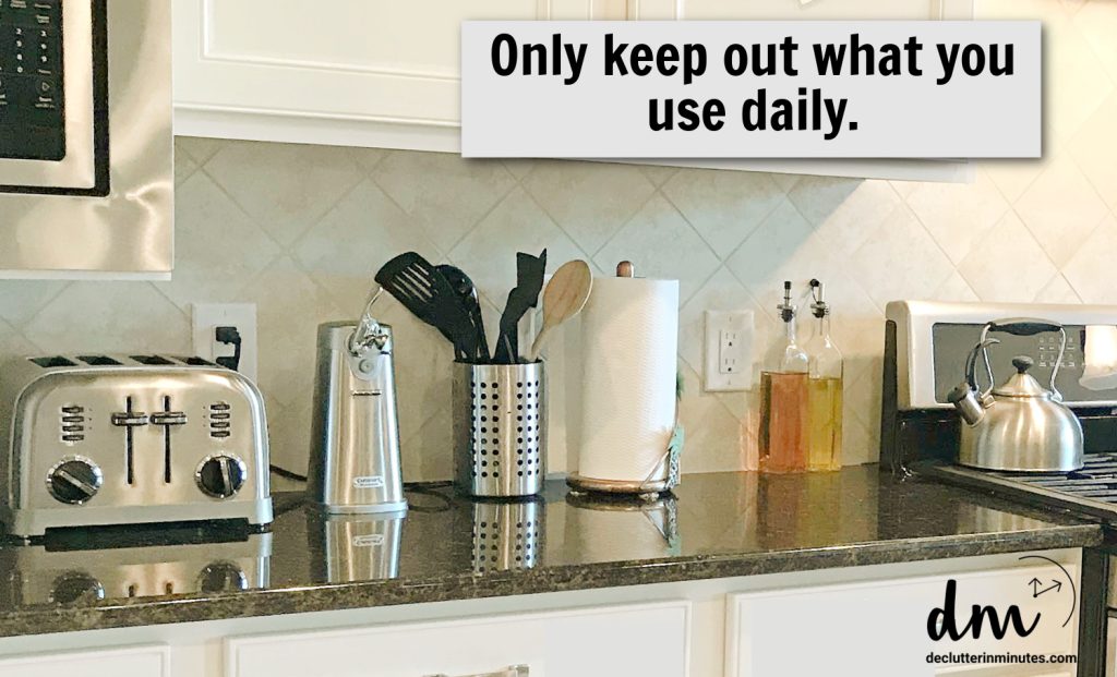 a counter in a kitchen lined with small gadgets-words _only keep out what you use daily