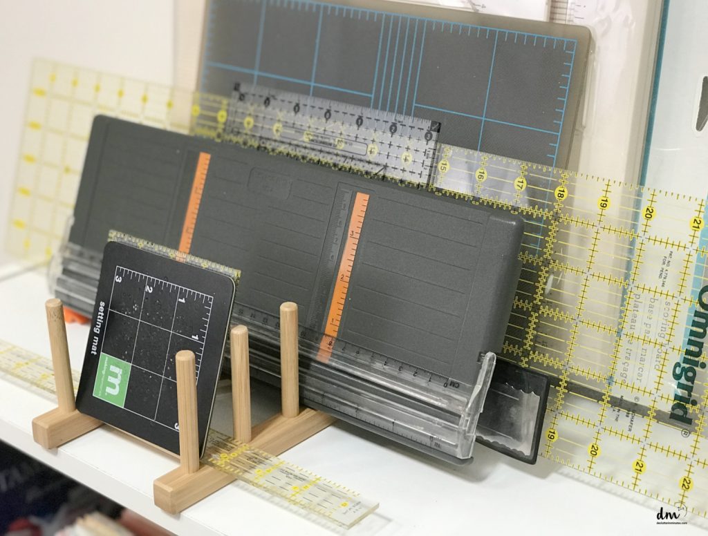 a file holder with fabric and paper cutters stored on