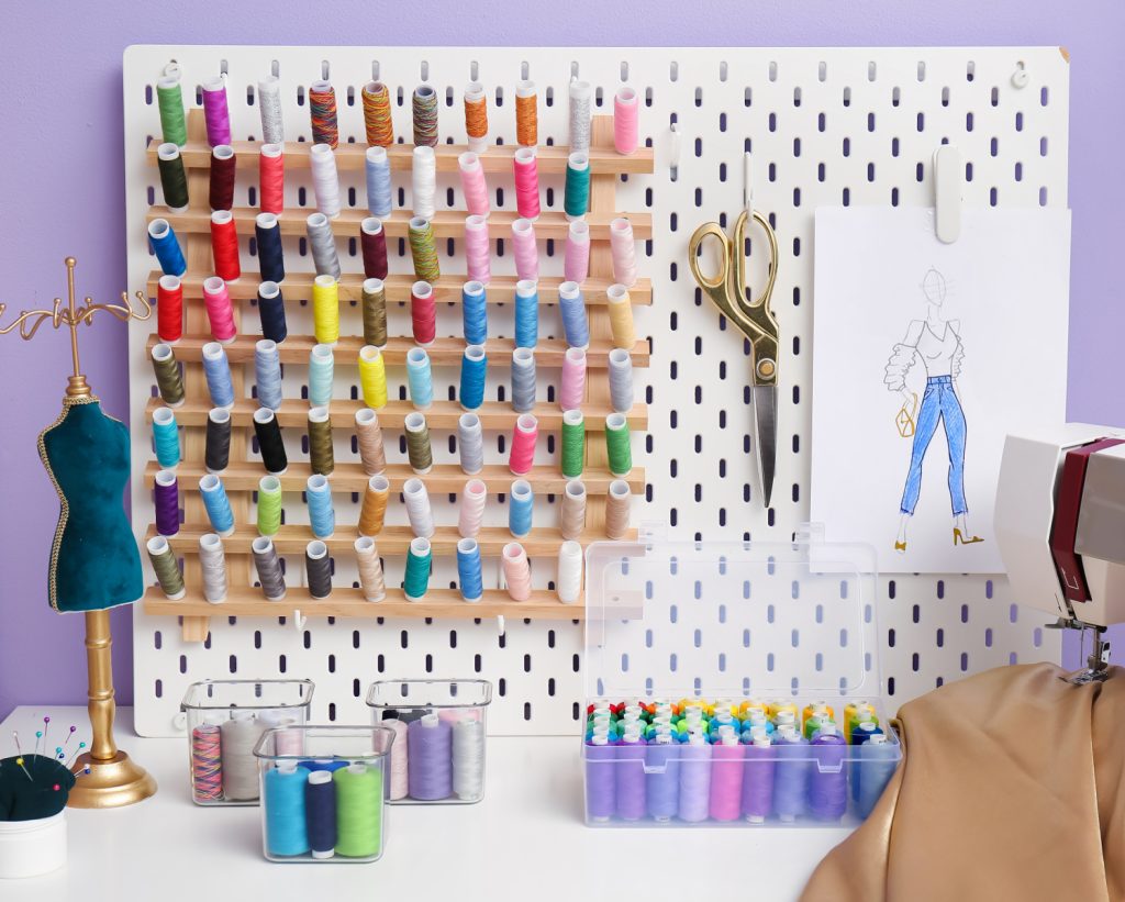 a pegboard that is holding a thread organizer