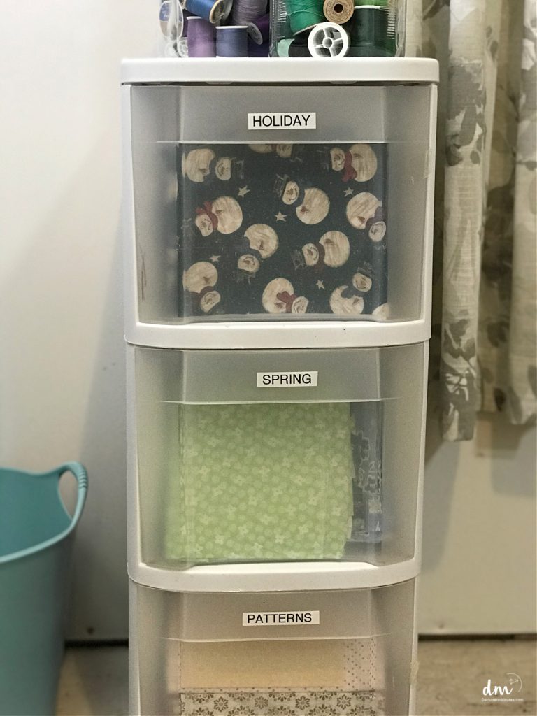 a plastic drawer setup with fabric stored inside