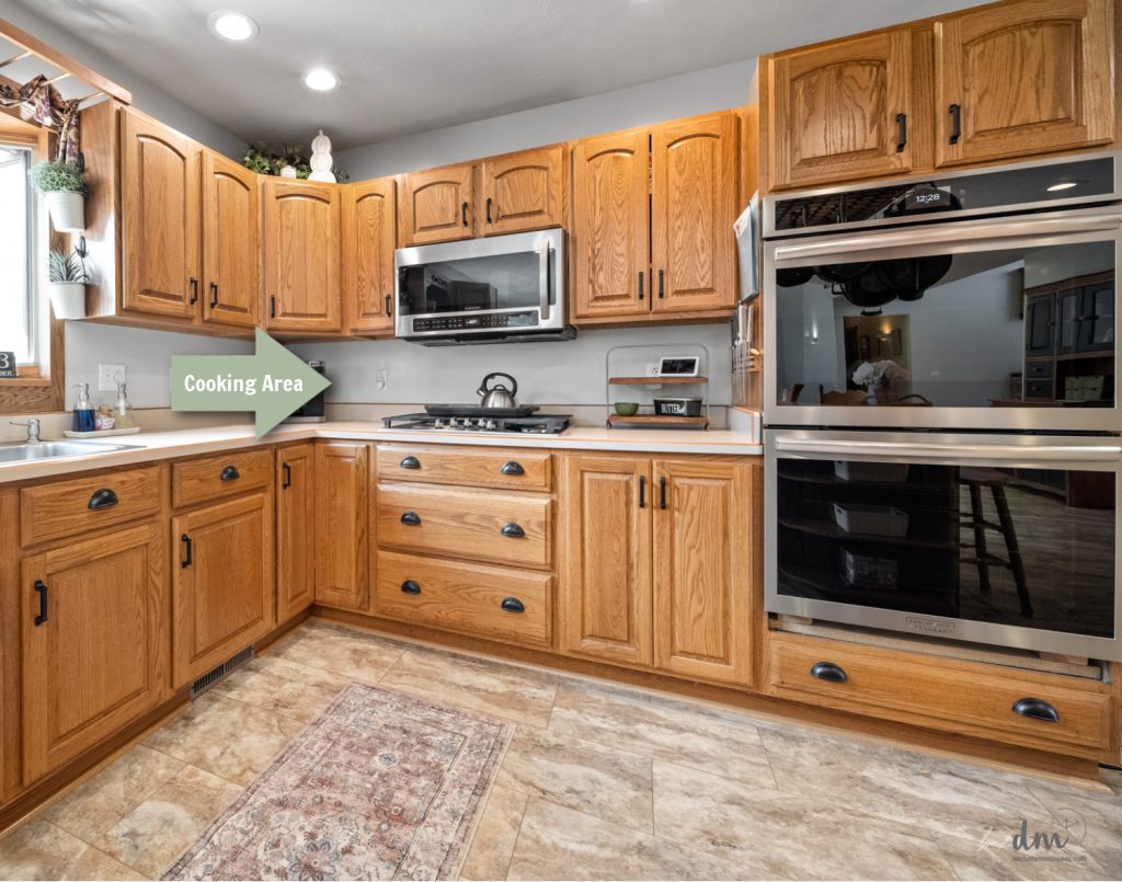 a stove top and double oven in a kitchen layout with a green arrow and the words _cooking area_