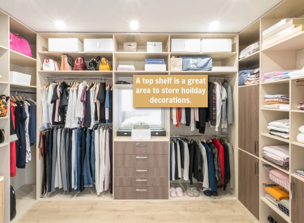 arrows pointing to a top shelf in a closet for storage of holiday decorations