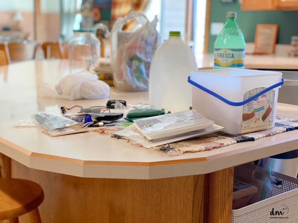 clutter and mess on a counter in a kitchen