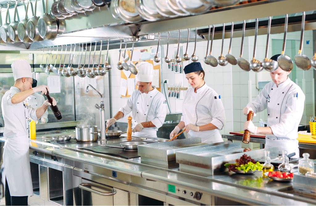 Modern kitchen. The chefs prepare meals in the restaurant's kitchen.