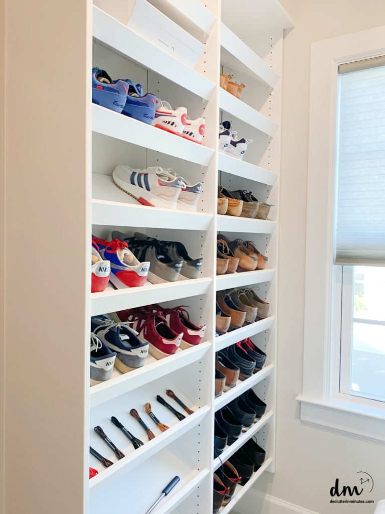 shelves in a closet that hold shoes and shoe strings