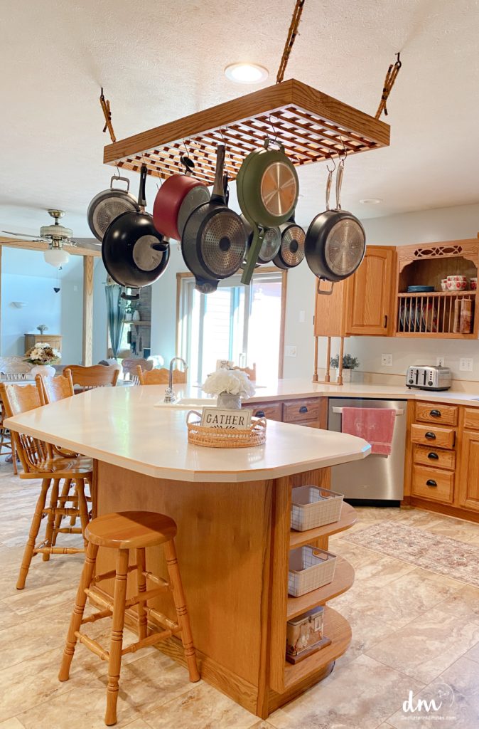 a pot rack hanging in a kitchen