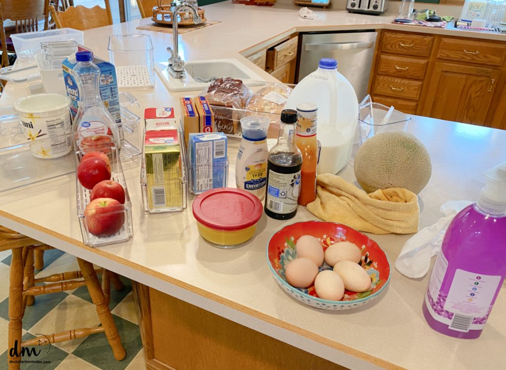 food from a fridge sorted on a kitchen counter