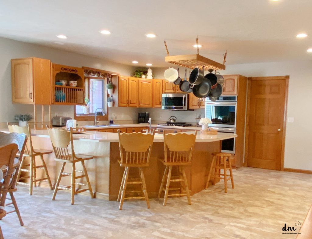 a photo of a kitchen that is brown and neat and organized