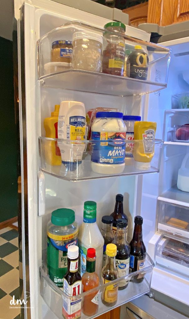 condiments stored in the door of a fridge