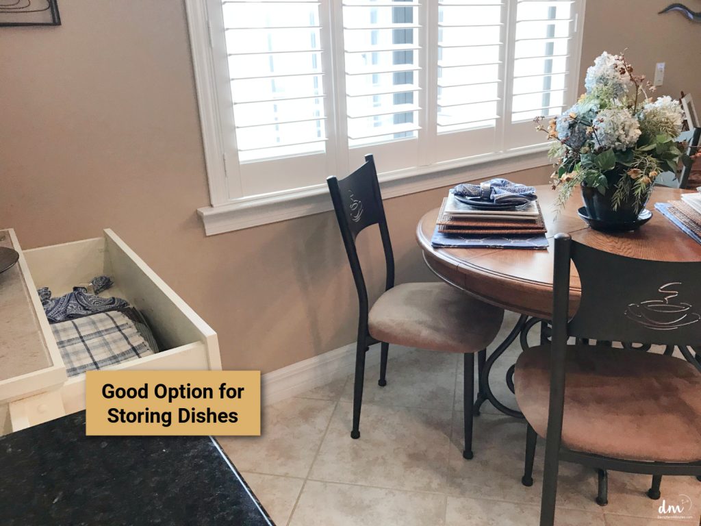 an open drawer near to a kitchen table