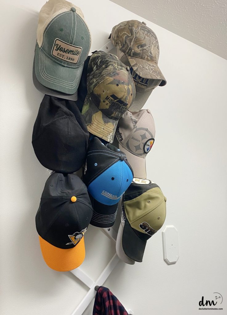hats hanging on hooks in a bedroom